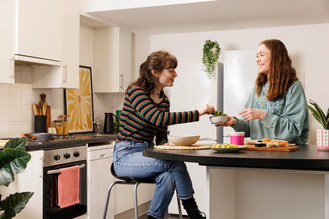 Two students preparing food at a modern kitchen at Murano House in Edinburgh Student Accommodation