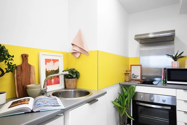 Kitchen with sink cutting board art microwave and oven kitchen at Trafalgar Hall in Portsmouth Student Accommodation