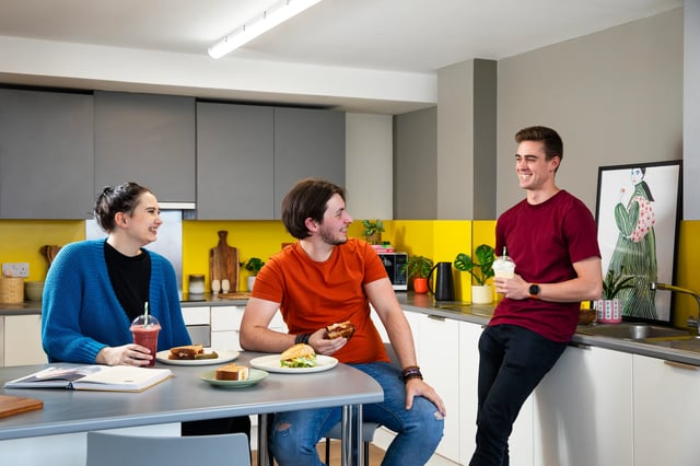Three students eating and talking kitchen at Trafalgar Hall in Portsmouth Student Accommodation