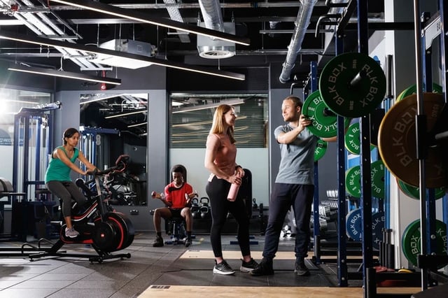 Gym with people on bike and weights at Arch View House in London Student Accommodation