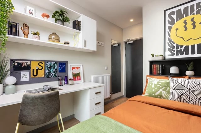 Desk chair shelves bed and artwork bedroom at Arch View House in London Student Accommodation