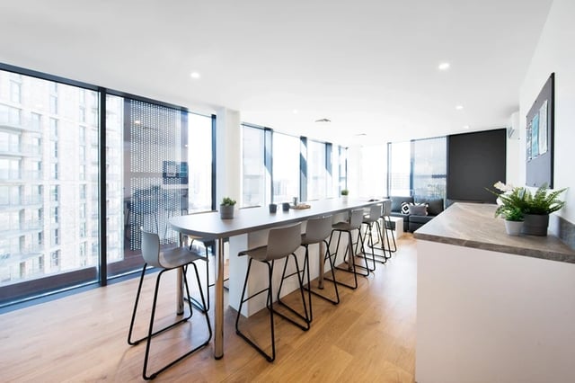 Bar stools along long counter with city view common area at Arch View House in London Student Accommodation