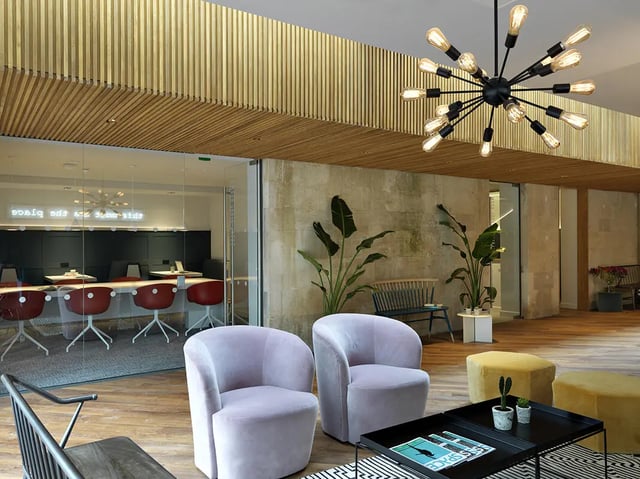 Velvet chairs plants modern lighting communal area at Student Castle Bath in Bath Student Accommodation