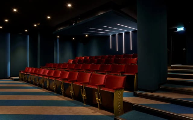 Red tiered seating with blue striped carpet cinema at Student Castle Durham in Durham Student Accommodation