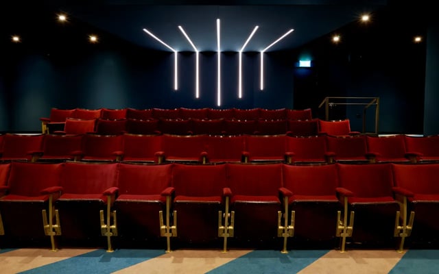 Rows of red velvet cinema seats with gold arms cinema at Student Castle Durham in Durham Student Accommodation