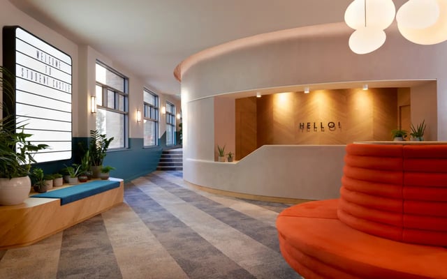 Welcome sign plants orange bench reception area lobby at Student Castle Durham in Durham Student Accommodation
