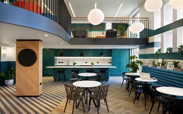 Modern kitchen and seating area with tables at Student Castle Durham in Durham Student Accommodation
