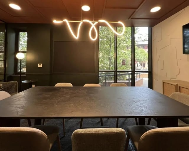 Large table chairs modern lighting communal area at Student Castle Reading (New Century Place) in Reading Student Accommodation