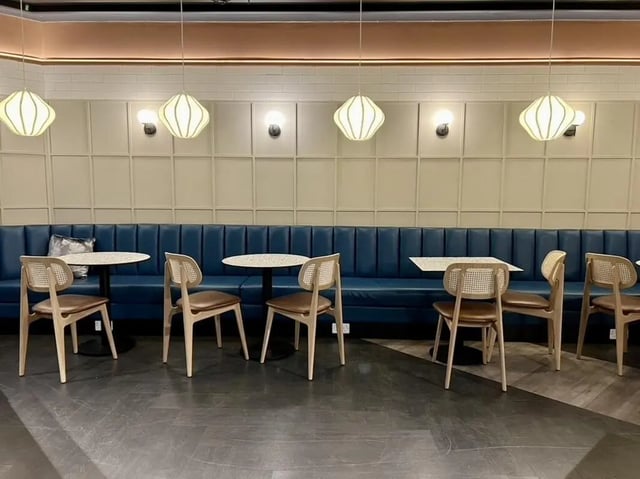 Blue booth seating with chairs and tables communal area at Student Castle Reading (New Century Place) in Reading Student Accommodation