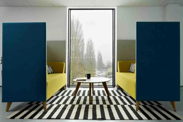 Yellow sofas coffee table privacy booths living room at Westwood Student Mews in Coventry Student Accommodation