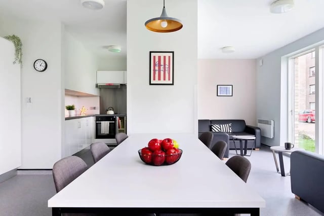 White table apples kitchen black sofa living room at Westwood Student Mews in Coventry Student Accommodation