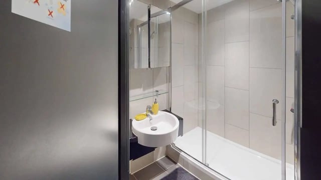 Sink shower cabinet with mirror bathroom at Opto village in Luton Student Accommodation