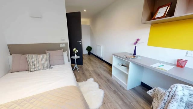 Bed desk and rug bedroom area at Opto village in Luton Student Accommodation