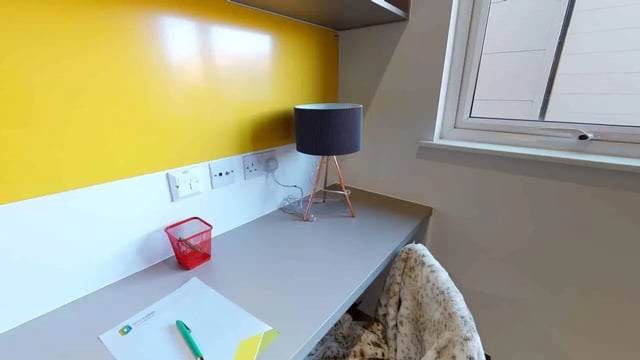 Desk with lamp paper pen bin study area at Opto village in Luton Student Accommodation