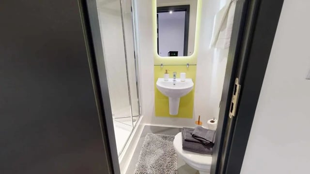 Sink shower toilet towels rug bathroom at Opto village in Luton Student Accommodation