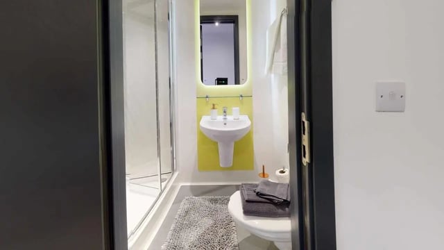 Shower sink toilet with towels bathroom at Opto village in Luton Student Accommodation