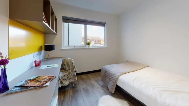 Desk bed lamp shelves magazines study area bedroom at Opto village in Luton Student Accommodation