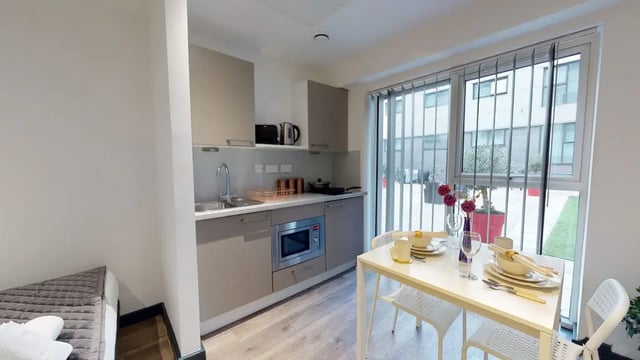 Kitchenette with dining table and bed Bedroom at Opto village in Luton Student Accommodation