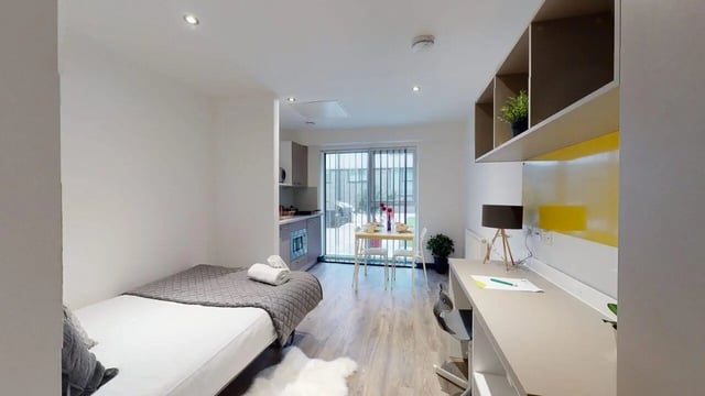 Bed kitchen dining desk and living room at Opto village in Luton Student Accommodation