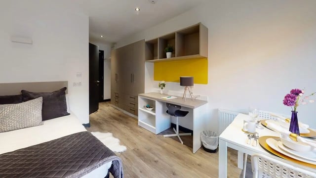 Bed desk wardrobe and dining table studio at Opto village in Luton Student Accommodation