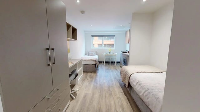 Two beds desk wardrobe kitchen area studio at Opto village in Luton Student Accommodation