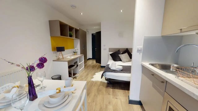 Bed study area kitchen and dining area at Opto village in Luton Student Accommodation