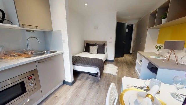 Bed kitchen study desk storage and microwave bedroom at Opto village in Luton Student Accommodation