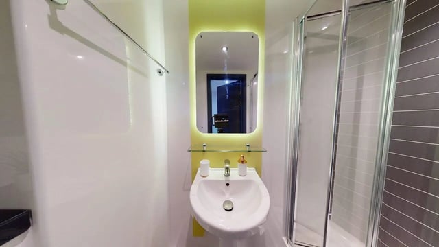 Sink mirror and shower enclosure bathroom at Opto village in Luton Student Accommodation