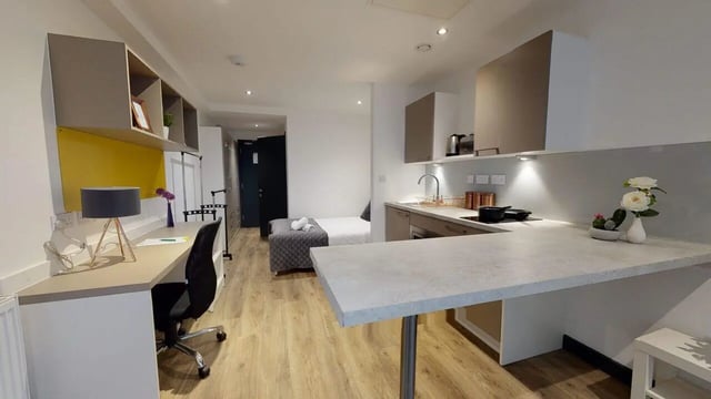 Desk bed kitchen counter sink and cabinets studio apartment at Opto village in Luton Student Accommodation