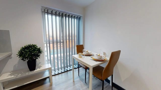 Dining table with place settings and chairs living room at Opto village in Luton Student Accommodation