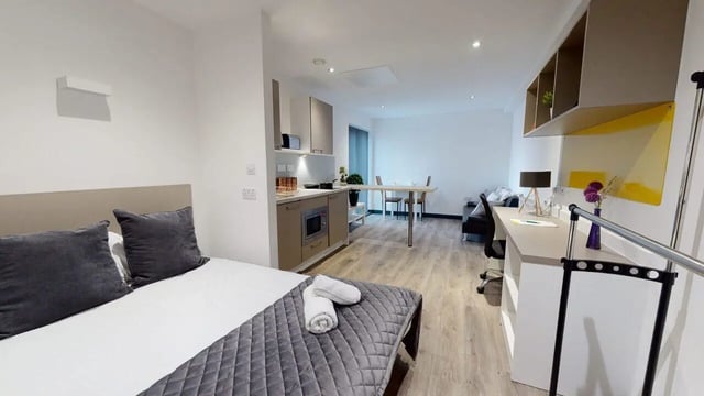 Bed kitchen desk sofa student studio at Opto village in Luton Student Accommodation