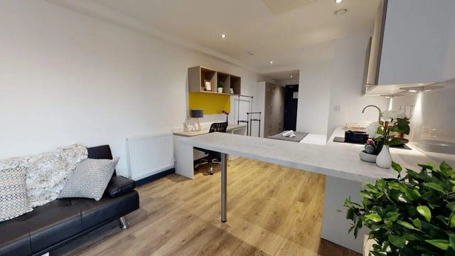 Sofa desk bed kitchen counter living room at Opto village in Luton Student Accommodation