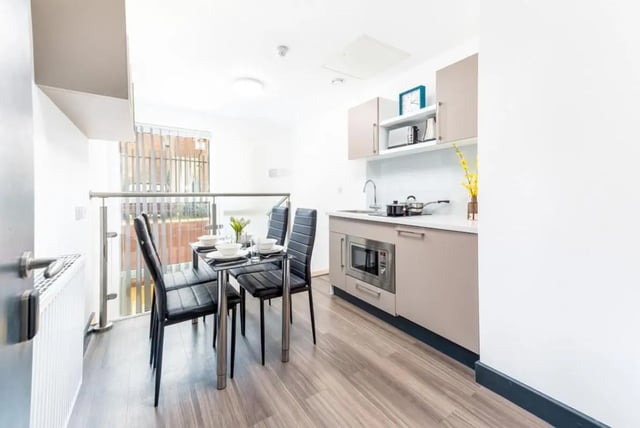 Dining table chairs microwave sink kitchen area at Chapel Street - Luton in Luton Student Accommodation