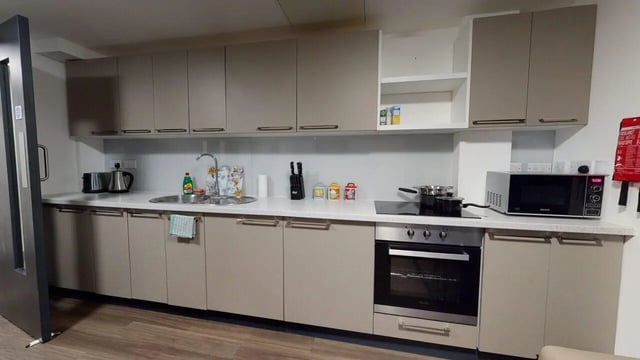 Kitchen with microwave oven and cupboards kitchen at Chapel Street - Luton in Luton Student Accommodation