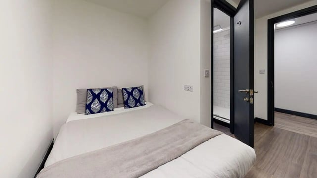 Bed with patterned pillows and throw bedroom at Chapel Street - Luton in Luton Student Accommodation