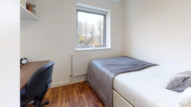 Bed desk chair alarm clock window bedroom at Park House in Luton Student Accommodation