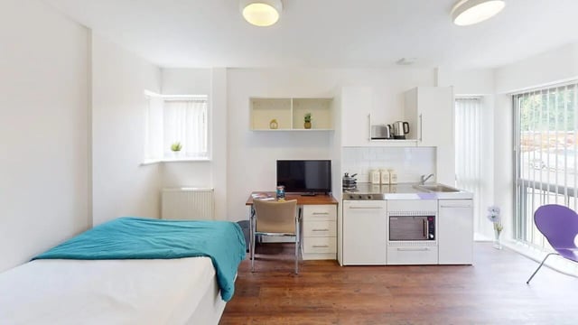 Bed desk kitchen and tv studio apartment at Park House in Luton Student Accommodation