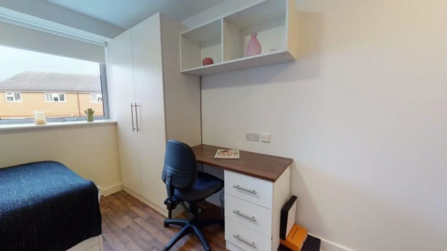 Bed desk chair shelves and wardrobe bedroom at Park House in Luton Student Accommodation