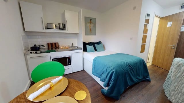 Bed kitchen white cabinets and stove bedroom at Park House in Luton Student Accommodation