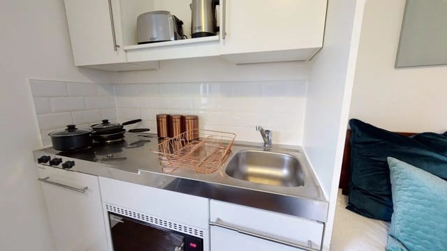Pots pans toaster kettle sink dish rack kitchen at Park House in Luton Student Accommodation