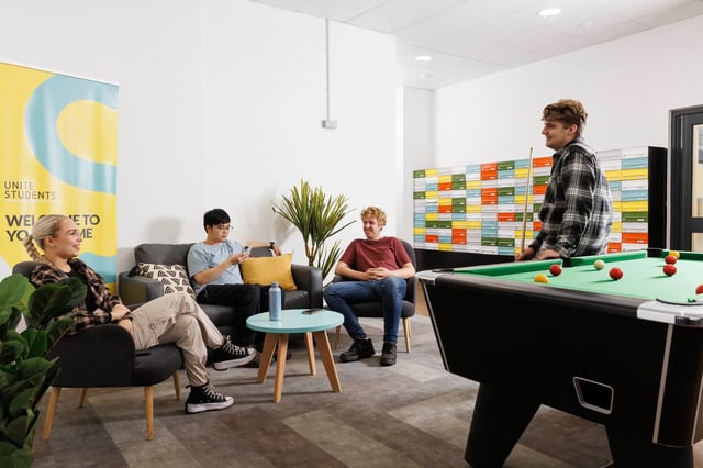 Students playing billiards and relaxing common area at Rosalind Franklin Halls in Portsmouth Student Accommodation