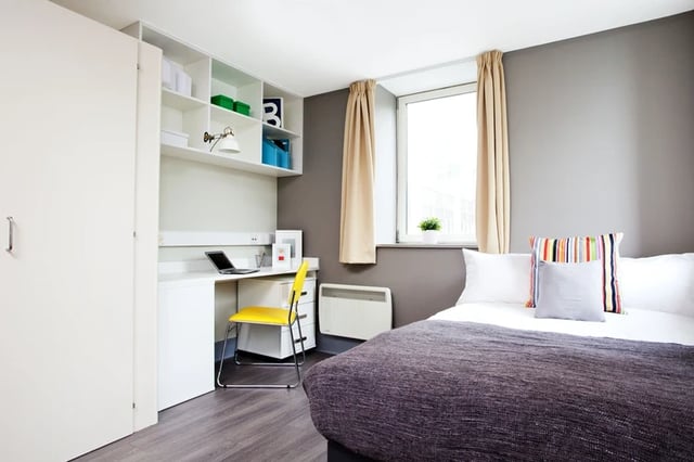 Bed desk chair shelves laptop and closet bedroom at Margaret Rule Hall in Portsmouth Student Accommodation
