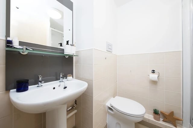 Sink, toilet, mirror, and toilet roll Bathroom at Mill Point in Manchester Student Accommodation