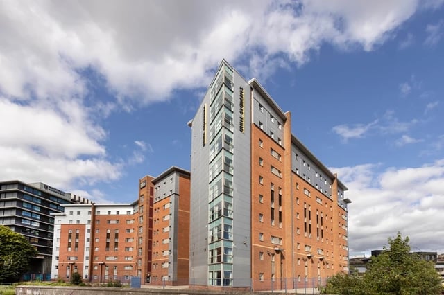 Brick student accommodation building with many windows exterior at Mill Point in Manchester Student Accommodation