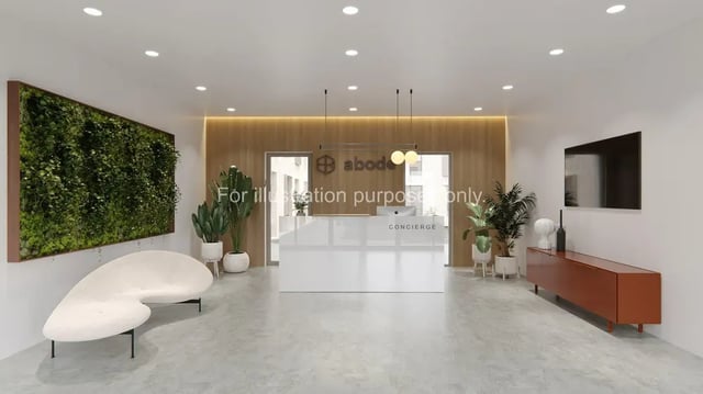 Living area with white couch and concierge desk. at Axiom in Stoke-On-Trent Student Accommodation