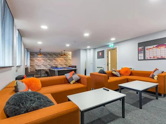 Orange sofas pool table tables communal area at Mary Parker House in Plymouth Student Accommodation