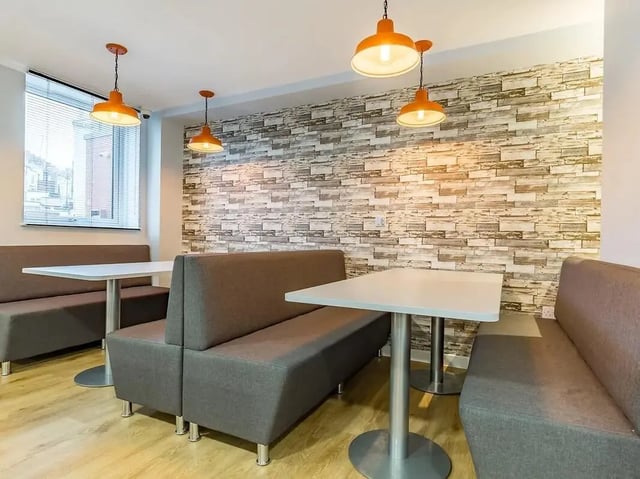 Gray booth seating and tables communal area at Mary Parker House in Plymouth Student Accommodation
