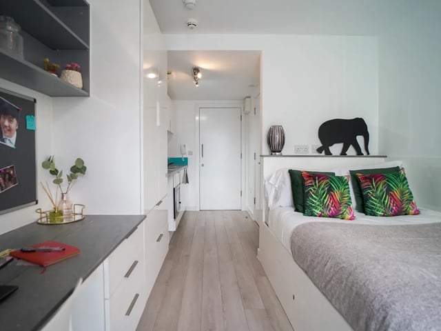 Bed desk kitchen and door studio apartment at The Recording Rooms in Birmingham Student Accommodation