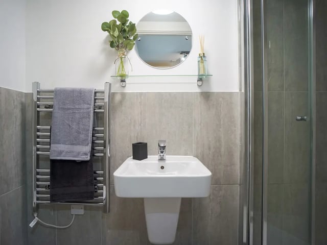 Sink towels radiator mirror shower bathroom at The Recording Rooms in Birmingham Student Accommodation