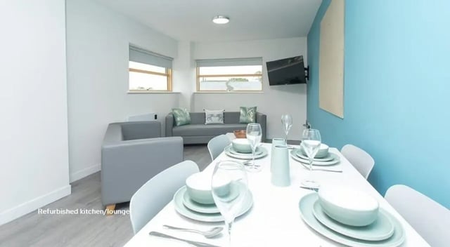 Sofa dining table set and TV living area at Abode York in York Student Accommodation
